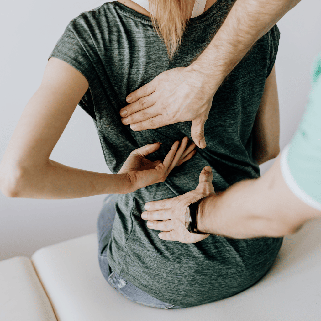 Chiropractor touching back